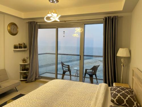 a bedroom with a bed and a view of the ocean at BEAUTIFUL STUDIO APARTMENT IN AL MARJAN ISLAND in Ras al Khaimah
