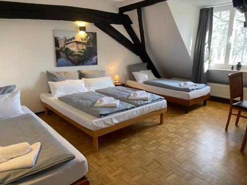 a bedroom with two beds in a room at Hotel Schloss Walbeck in Geldern