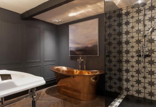 a bathroom with a copper tub and a sink at Derwent Manor Boutique Hotel in Consett