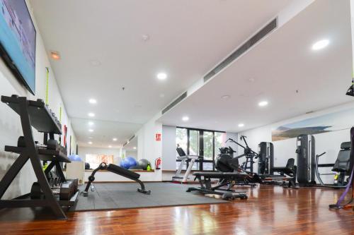 a gym with treadmills and elliptical machines at Hotel Escuela Santa Cruz in Santa Cruz de Tenerife