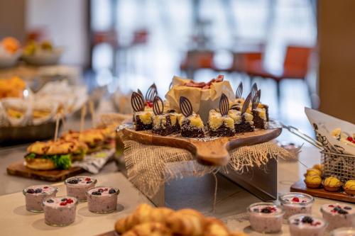 a table topped with desserts and pastries on a table at Sheraton Zürich Hotel in Zürich
