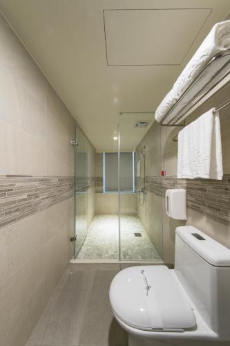 a bathroom with a toilet and a walk in shower at XinsheHotel - Chungli in Zhongli