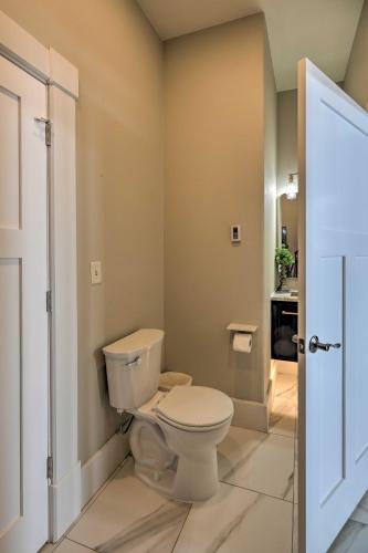 a bathroom with a white toilet in a room at Regal River Retreat in the Heart of Yankton! in Yankton