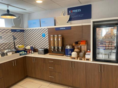 a counter in a fast food restaurant with a cash register at Holiday Inn Express Hotel & Suites White River Junction by IHG in White River Junction