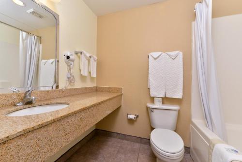 a bathroom with a sink and a toilet at Americas Best Value Inn & Suites-Winnie in Winnie