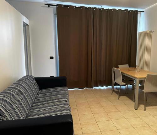 a living room with a couch and a table at Residence La Settima in Milano Marittima