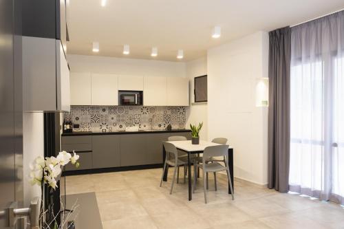 a kitchen with a table and chairs in a room at Amiata Suite in Abbadia San Salvatore