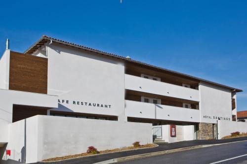 a white building with a sign that reads are restaurant at Hotel Restaurant Santiago in Hendaye