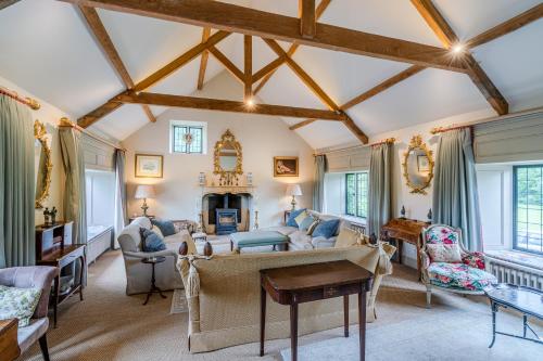a living room filled with furniture and a fireplace at Grindstone Mill in Alderley