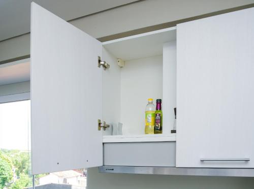 a kitchen with white cabinets and a window at N3A1 - New, Nice, for Long and Short Stay in Asuncion