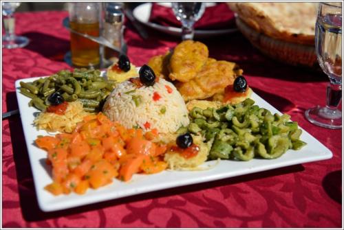 a plate of food with rice and vegetables on a table at Taloute Ecolodge in Skoura