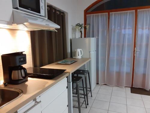 a kitchen with a refrigerator and a counter top at Bompastor in Bompas