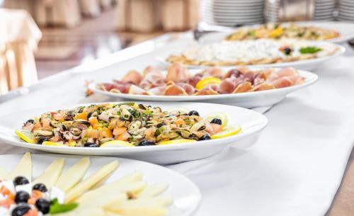 a table with three plates of food on it at Villa Arausa in Vodice