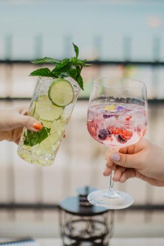 two people holding a drink in a wine glass at Villa Arausa in Vodice