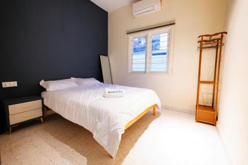 a bedroom with a bed and a window and a ladder at monstera homestay near Tambun, Ipoh Garden East in Ipoh