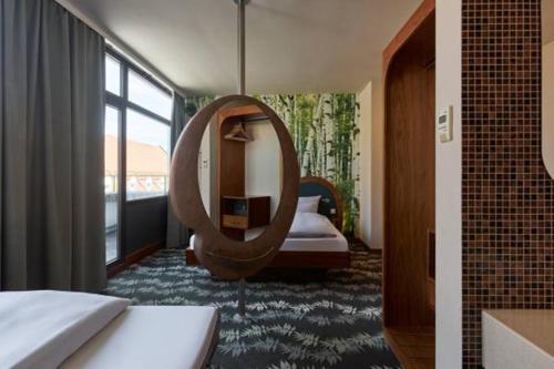 a bedroom with a large mirror and a bed at Cocoon Stachus in Munich