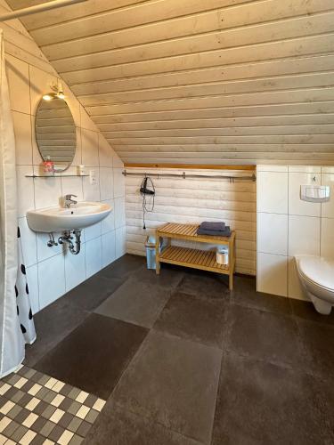 a bathroom with a sink and a toilet at Apartments im Schwedenstil in Papenburg