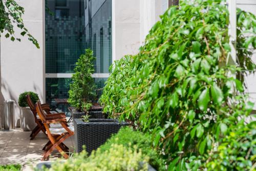 a patio with a bench and trees on a building at Hotel Sandwirth in Klagenfurt