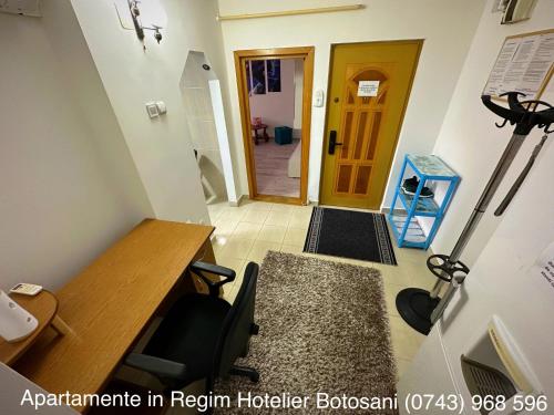 an office with a desk and a yellow door at Apartament Uvertura Mall/Lidl cu parcare gratuita in Botoşani