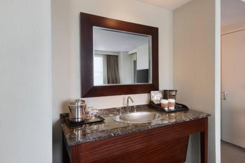 a bathroom with a sink and a mirror at The Westin Reston Heights in Reston