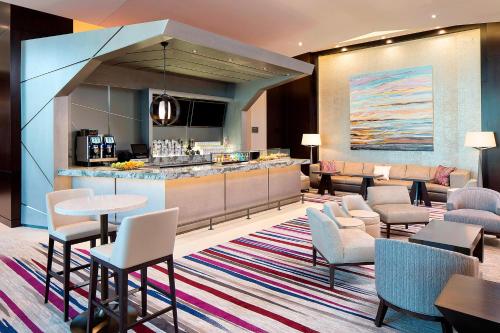 a hotel lobby with a bar and tables and chairs at The Westin Edina Galleria in Edina