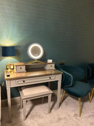 a dressing table with a mirror and a chair at Ashbourne House in York