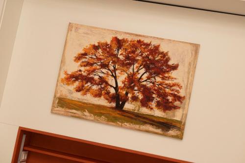 a painting of a tree on a wall at Vicolo Zini Apartments in Verona