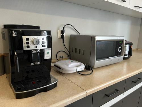 a kitchen counter with a coffee maker and a microwave at Pokoje u Hani - sauna, balia z hydromasażem in Bukowina Tatrzańska