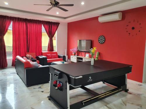 a living room with a black piano in a living room at Homey Homestay in Tanjong Sepat