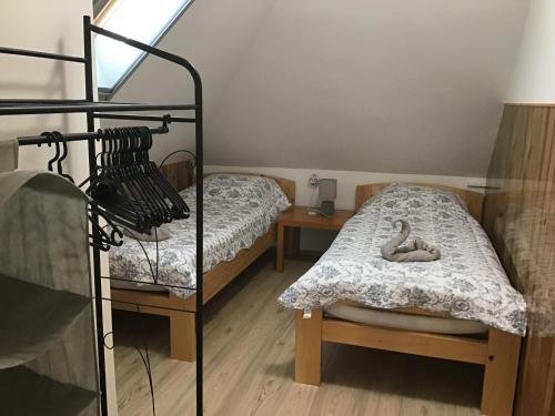 a bedroom with two beds and a bed with a doll at Citellus Apartman in Dunasziget