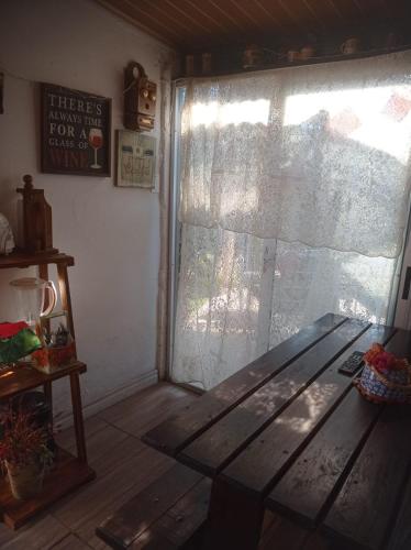 a room with a wooden bench in front of a window at Playa, bosque y lago in Montevideo