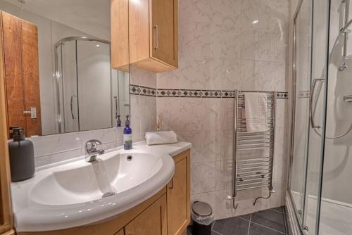 a bathroom with a sink and a shower at Guest Homes - Harrow Croft Dwelling in Worcester
