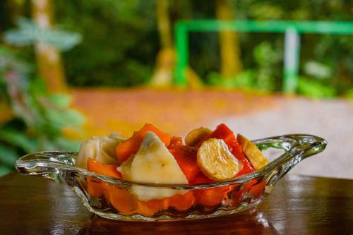 a glass bowl of fruit on a wooden table at Arenal Descanso in Fortuna