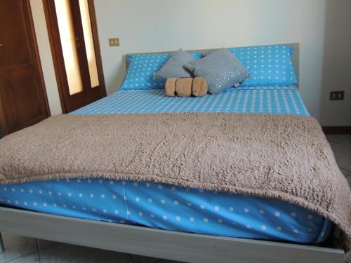 a bed with blue sheets and blue polka dots at Il Chicco apartment in Lamporecchio