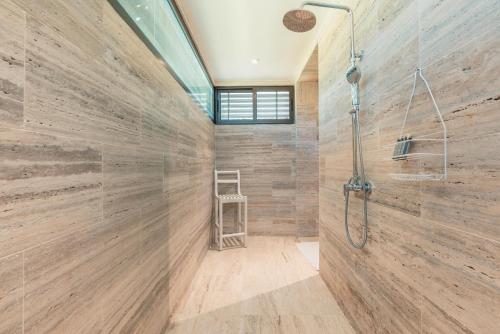 a bathroom with a shower and a glass wall at Newly Added 1BR El Portillo Luxury in Portillo
