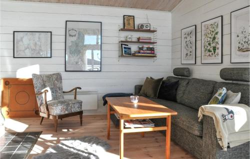 a living room with a couch and a table at Awesome Home In Åmotfors With Wifi in Åmotsfors