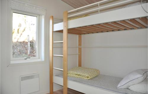 a bunk bed in a room with a window at Stunning Home In motfors With Lake View in Åmotsfors