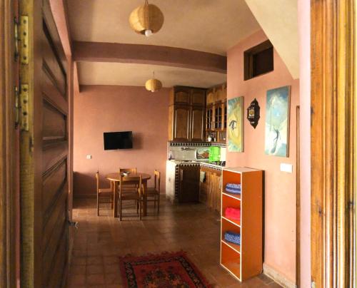 a kitchen and dining room with a table and chairs at Little Paradise House in Agadir