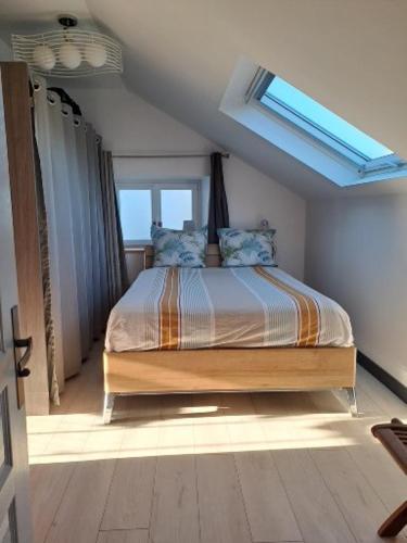 une chambre avec un lit dans une pièce avec une fenêtre dans l'établissement Ty-garde, à Peumérit