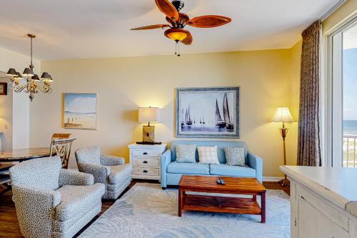 a living room with a blue couch and chairs at Spanish Key 304 in Perdido Key