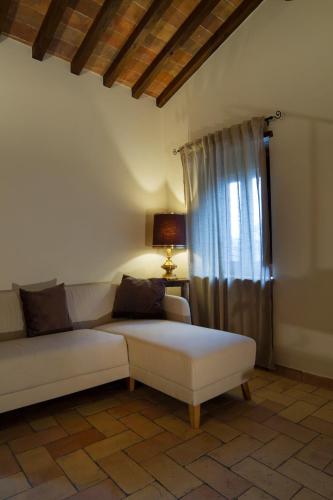 a living room with a white couch and a window at La Finestra su Civita in Lubriano