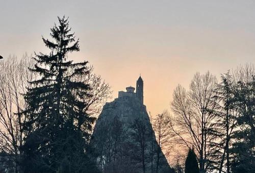 a building on top of a mountain with trees at gîte de Vialette in Rachat