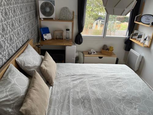 a bedroom with a bed in a small room at Chez Flo et Marc in Chouzy-sur-Cisse