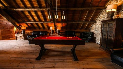 a pool table in the middle of a room at Hotel Xaluca Spa Aguelmame Sidi Ali in Aguelman