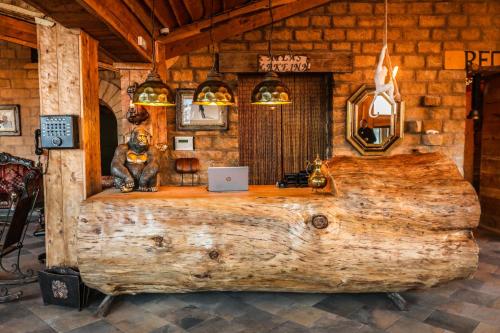 a room in a log cabin with a laptop on a desk at Hotel Xaluca Spa Aguelmame Sidi Ali in Aguelman