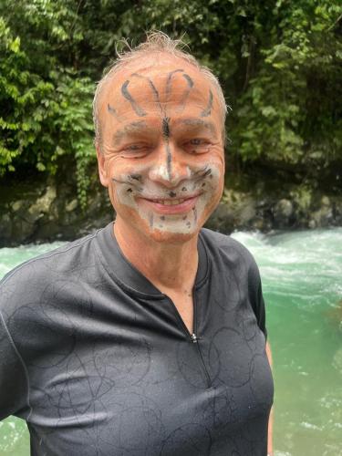 a man with a face painting of a spider on his face at Sumatra Thomas Leaf Monkey Guesthouse & Jungle Trek in Bukit Lawang