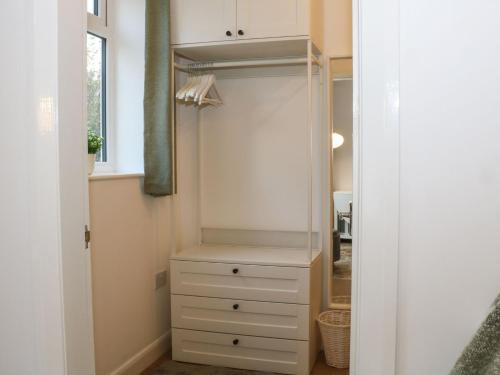 a closet with a white cabinet and a drawer at Hope Cottage in Hambleton