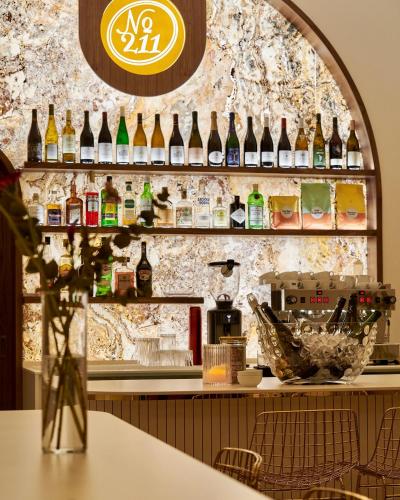 a bar with lots of bottles on the wall at Hotel Nerudova 211 in Prague