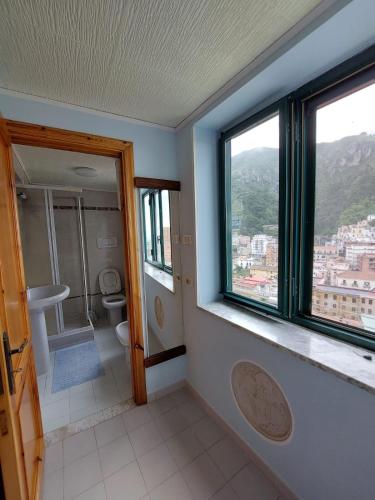 a bathroom with a toilet and a window at Casa Muse in Maiori