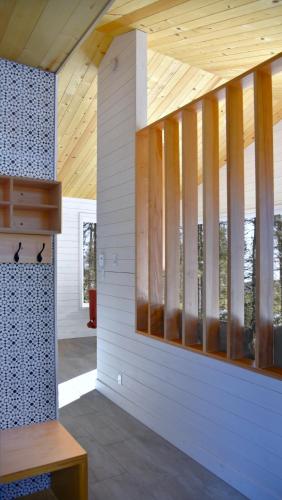 a building with a wooden ceiling with windows at Charlevoix expérience thermale en pleine nature - Suites Nature Charlevoix - Suite #1 in Les Éboulements